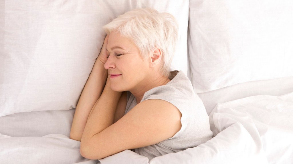Woman in bed sleeping soundly for brain health