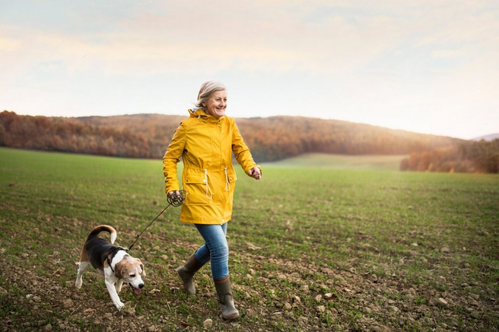 Older woman exercising with dog - fall prevention
