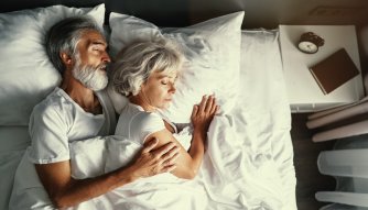 a couple sleeping together in bed