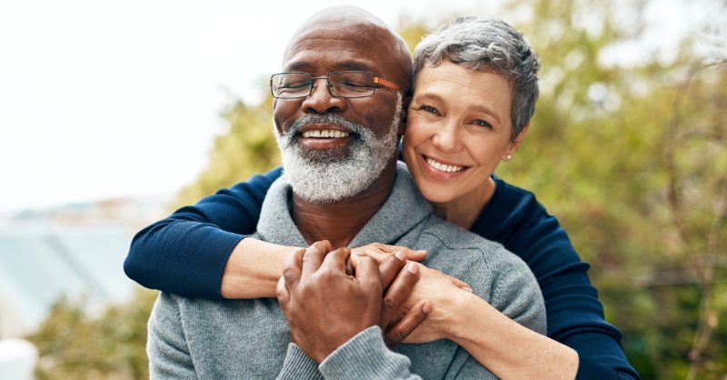 Hopeful older couple hugging