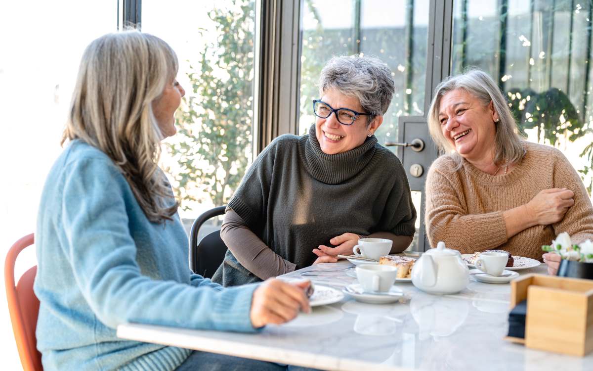 Women drinking coffee and laughing in Dry January