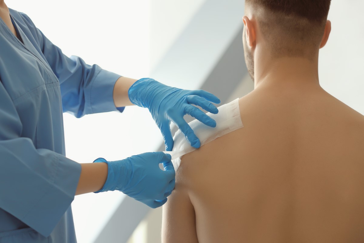 Doctor bandaging a wound