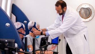Aviv Doctor helps patient in multiplace hyperbaric chamber